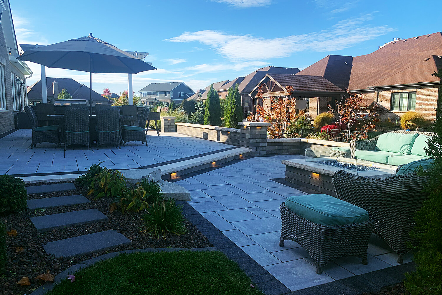 Design Transformation with Paver Patio, Fire Feature, and Landscape Design by A Touch of Green