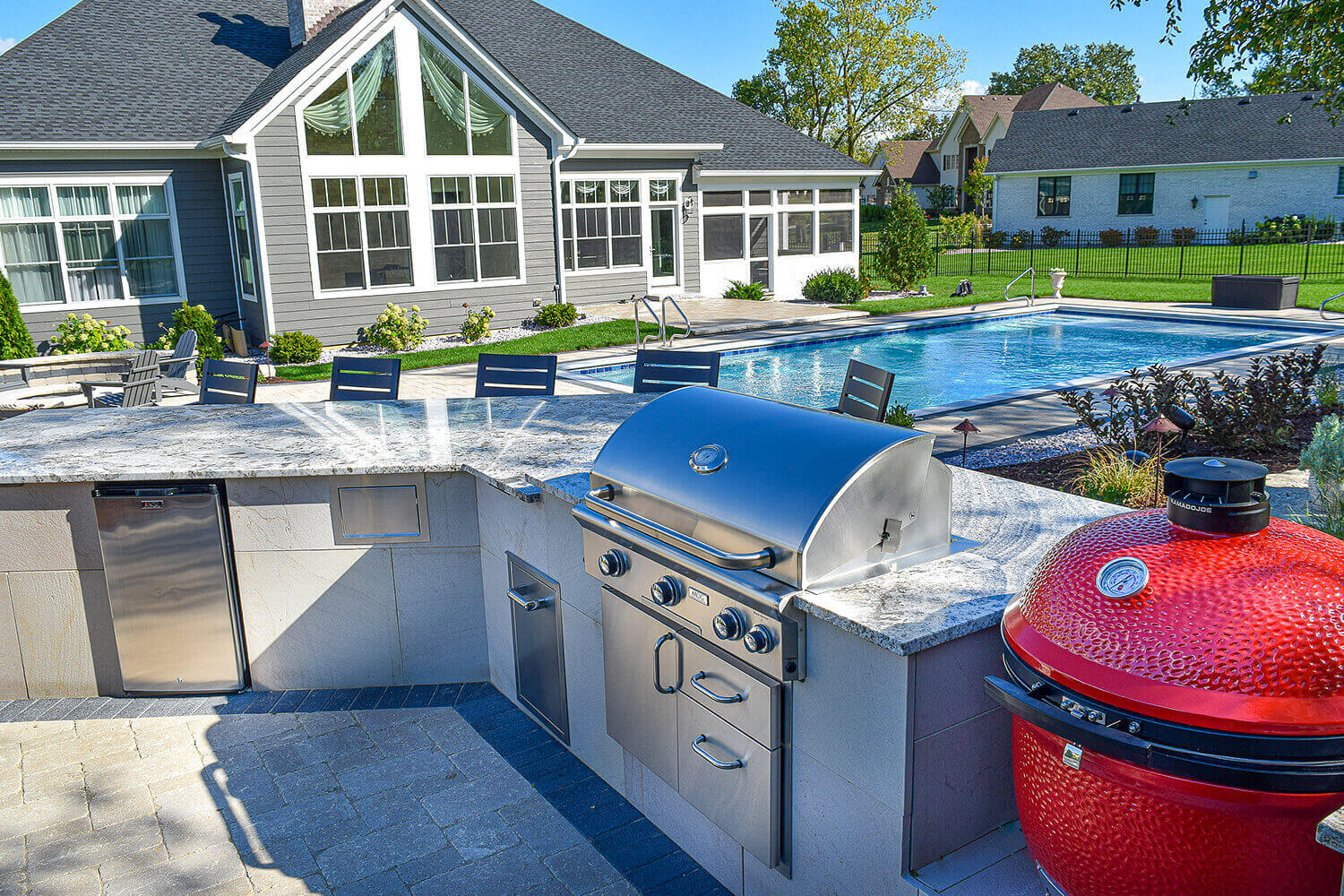 Outdoor Kitchen, Paver Pool Deck, and Landscape Design by A Touch of Green