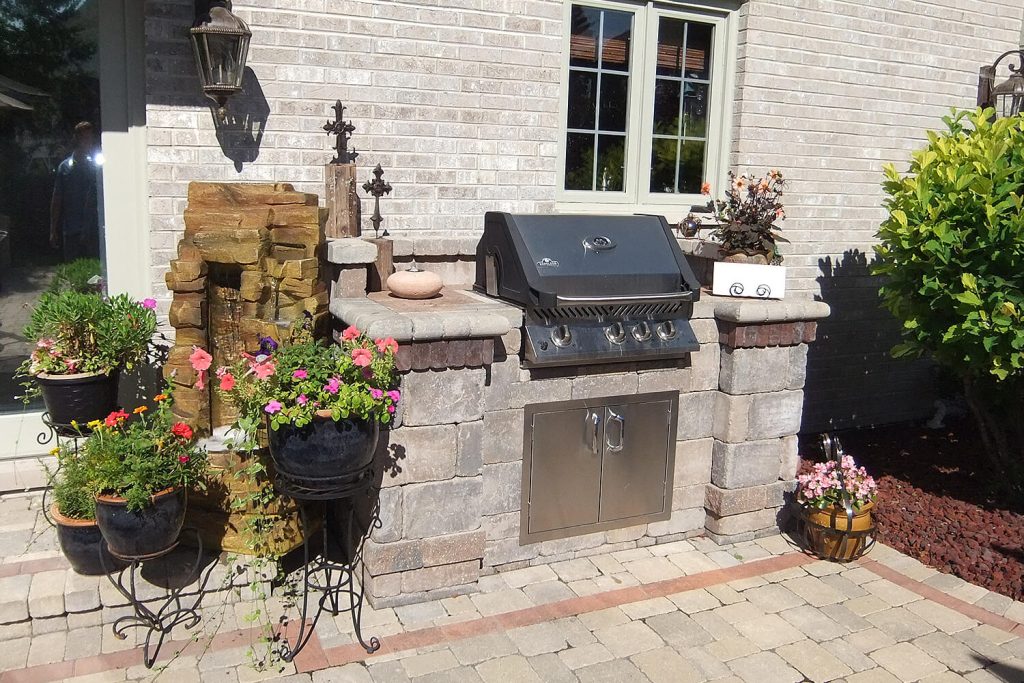Outdoor Kitchen, Pavers, and and Landscape Design by A Touch of Green