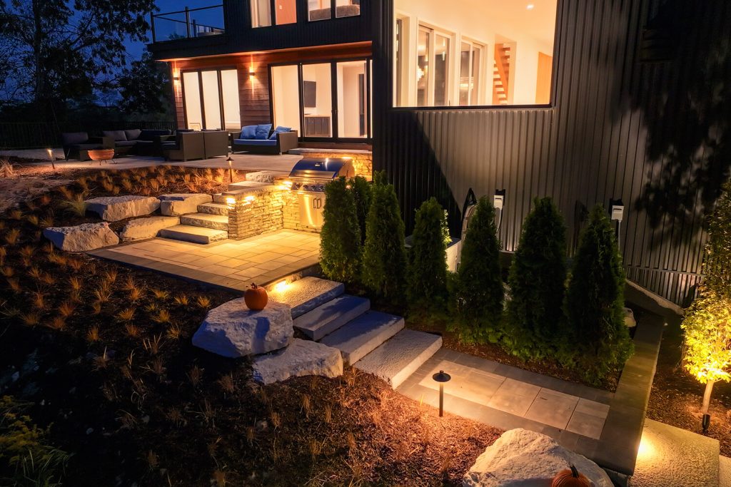 Outdoor lighting, paver and landscape design by A Touch of Green