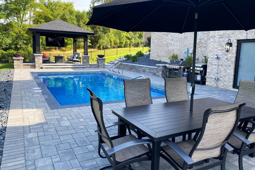 Pool Deck, Pavers, and Landscape Design by A Touch of Green